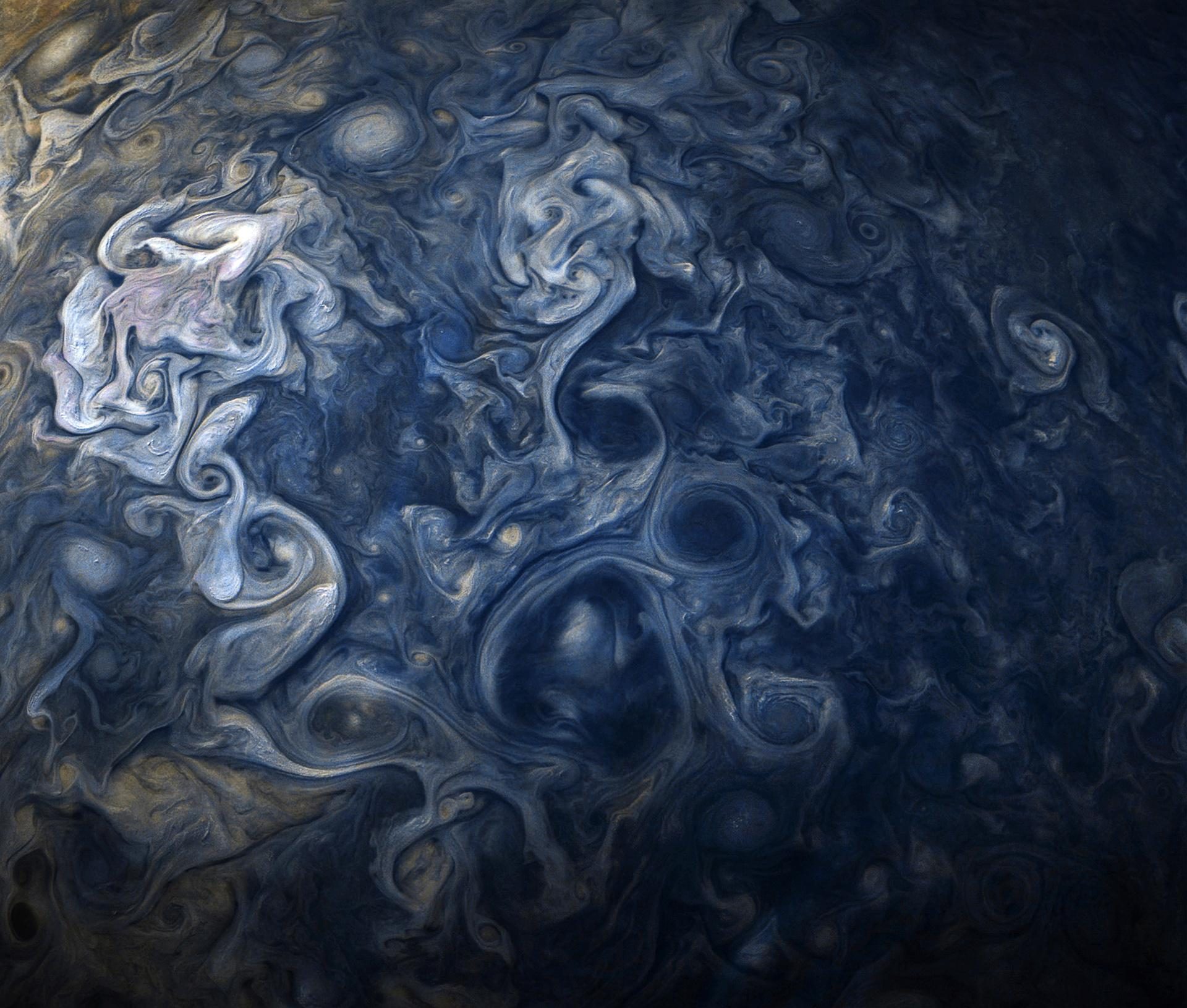 Juno’s close pass over Jupiter’s Great Red Spot, the anticyclone filling the frame like a landscape of rust and cream.